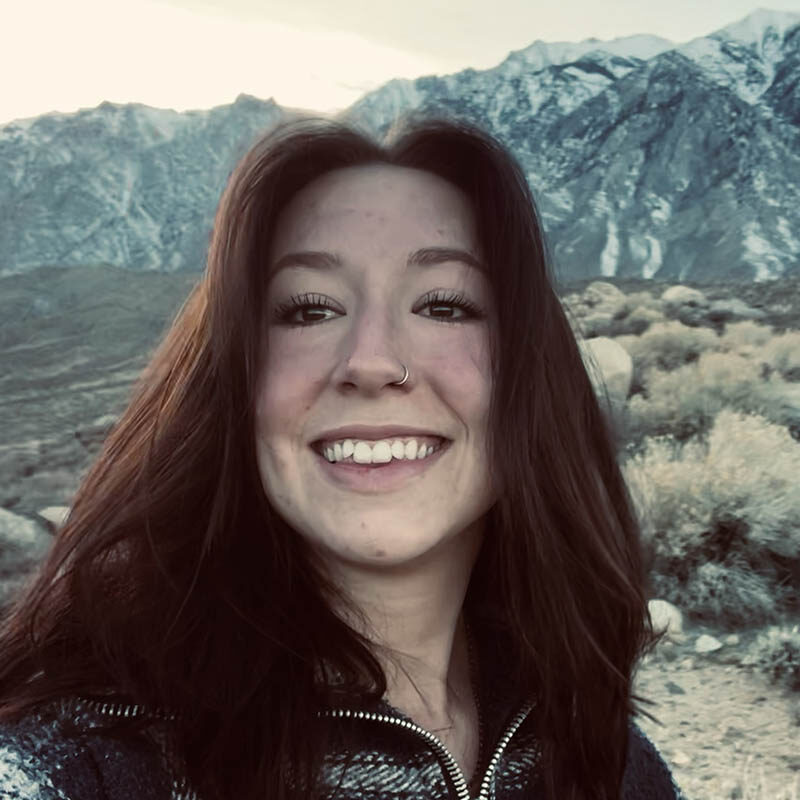 Alana Hall Bookkeeper lady smiling outdoors with mountains in the distance